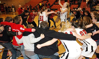Bradshaw Mountain seniors Katie Rogge, right, and Gabby Jeffries lead their teammates and brother Bears in a celebratory dance after the Lady Bears’ 47-45 overtime State playoff victory over Notre Dame in Prescott Valley Friday night.<br>
Trib Photo/Cheryl Hartz