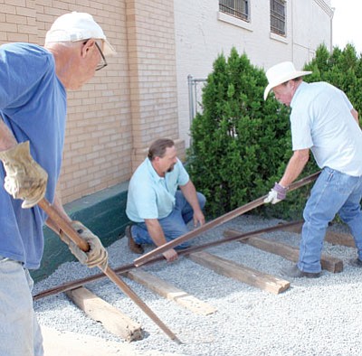 Members of the Dewey-Humboldt Historical Society prepare a site for the ore cart on the east side of the Historical Museum this past Wednesday. From left are Art Dietrich, John Young, and D-HHS President Kevin Leonard.<br>
Trib Photo/Sue Tone