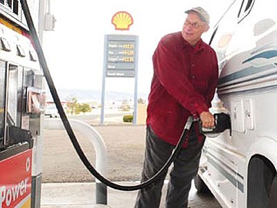 Steve Kaine of Prescott Valley pumps gas at the Shell Station on Robert Road and Highway 69 Tuesday morning. Kaine said he saw $2.99 gas in Phoenix yesterday and he can afford to pump premium gas when prices drop like they have recently.<br>
Photo courtesy Les Stukenberg