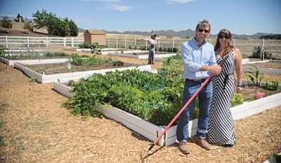 Les Stukenberg/The Daily Courier<br>David Grounds, president and CEO of Dorn Homes, and homeowner Laura Sutton pose in the Quailwood community garden in Prescott Valley.