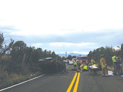 Central Yavapai Fire District first responders prepare a woman for transport to Yavapai Regional Medical Center East after a rollover accident Wednesday afternoon.<br>
Photo courtesy Joanna Dodder/The Daily Courier