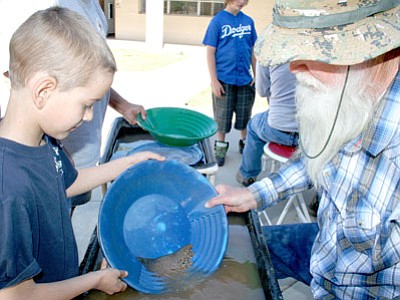 Brandon Minier, Mayer, left learns how to pan for gold from Woody Wampler. Wampler and other members of the Gold Prospectors Association of Phoenix and the Dewey-Humboldt Historical Society will be on hand at Saturday’s Old West Days in Humboldt.<br>
Trib File Photo/Sue Tone