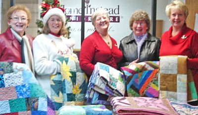 Jan Donovan, Lonesome Valley Quilt Guild publicity chairman, Chris Turner,  Community Project co-chair; Susan Abbott, franchise owner of BASTAS, Judy Lapp, Community Project co-chair; and Pamela Cregger, BASTAS’s Community Service Rep donate 21 quilts, knit shawls, neck pillows and pillowcase to “Be a Santa to a Senior.”<br>
Courtesy Photo
