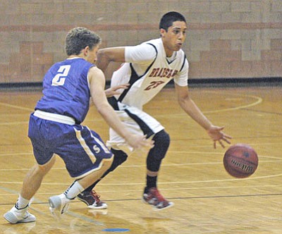 Bears’ sophomore Gilbert Ibarra drives toward the basket on an unidentified player from the Notre Dame bench Friday night in Prescott Valley.<BR>
TribPhoto/Cheryl Hartz
