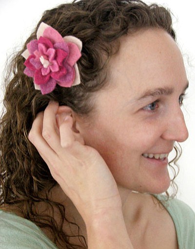 Tasha Miller Griffith shows off a felted 3-D flower hair clip she made. Griffith will be teaching a felting class at Arcosanti on Saturday.<br>
Courtesy Photo