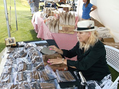 Josie Weber, owner of the Tony Santana Boulevard Cigar shop in Prescott Valley, rolls cigars during a fundraising event.<br>
Courtesy Photo