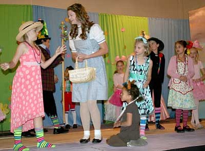 Trib Photo/Sue Tone<br>
Dorothy, played by Brooke Williams, finds herself and Toto, front, played by Kahlill Kerim, surrounded by munchkins in the Land of Oz in the Lonesome Valley Playhouse production of “Wizard of Oz.” Below is another glimpse of “Oz.”