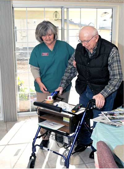 Courtesy Photo<BR>
Trinity Lutheran Church parish assistant Donna Voss eases Ed Leiding from his wheelchair to his walker.
