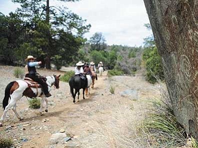 Les Stukenberg/The Daily Courier<br /><br /><!-- 1upcrlf2 -->Members of the Granite Mountain Riders equestrian group ride by the petroglyphs along the 95 (Salida Gulch) trail in the Prescott National Forest on May 6.