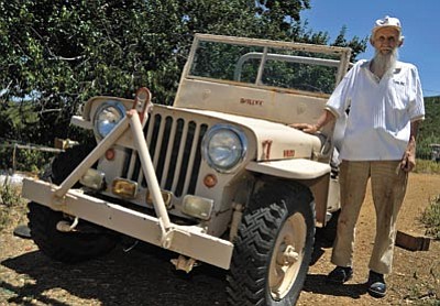 Veteran Kenneth Nipple stands next to his 1940 Willy's Jeep Tuesday afternoon at his home in Dewey. Nipple was an assistant tank driver in the European Theater during World War II. (Matt Hinshaw/The Daily Courier)