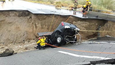 Emergency crews respond after a pickup truck crashed into the collapse of an elevated section of Interstate 10, Sunday, July 19, 2015. (Chief Geoff Pemberton/CAL FIRE/Riverside County Fire via AP)