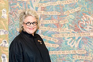 Photo courtesy of www.gregorycase.com
<br>Mary Fisher against the backdrop of one of her best-known quilts.
