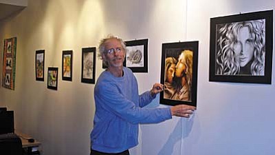 Geoffrey Worssam, art teacher at Sedona Red Rock High School, displays student art work at SPL-V