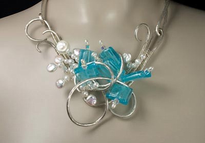 “Gifts From the Heart” opens at Lanning Gallery on “1st Friday” and features a variety of Valentine’s Day gift ideas such as “Waves on the Rocks” by Valerie Ostenak, a neckpiece of forged silver, silvered glass, freshwater pearls and Swarovski crystals.