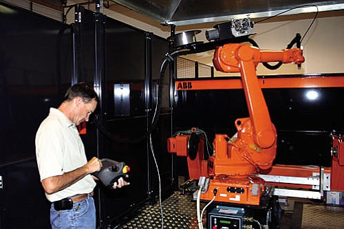 Sonny Zale, owner of Integrated Systems West, designs and programs robots for use in manufacturing where repetitive motion is required. The robots are used for machine tending, palletizing, welding and packaging. Zale buys the robots then designs the proper tooling and delivery systems for the machines to do specific jobs for customers.