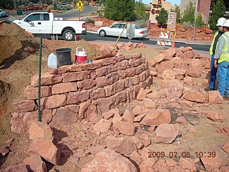 Photo courtesy of ADOT
Landscaping work has begun in the inner circle of the roundabouts in the Village. This picture shows a small red rock wall being built in the roundabout circle at Ridge Trail and Avenida de Piedras.