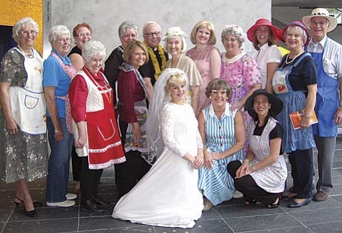 Photo by Michelle Borgwardt
Adorned in vintage aprons and hats, a dozen members of the Arizona Giving Circle from the Verde Valley joined cast members of the musical Church Basement Ladies in celebration of church basement kitchens everywhere. Back row from left: Pat Eudy, Betty Hanf, Karen Colby, Barbara Osher, actor William Christopher, Cynthia Strom, actresses Katherine Proctor and Jean Liuzzi, Stephanie Stackhouse, and Shari and Bill Witt. Front row from left: Billie Winkle, Joan Bourque, actresses Jessica Taige and Karen Pappas, and Claudia Alarcon.