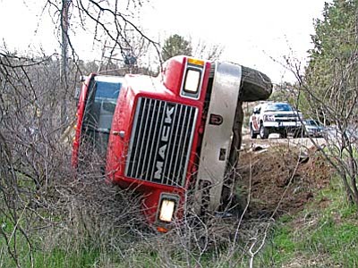 Courtesy photo<br/>A full dump truck toppled off Page Springs Road Monday. The driver was not injured.