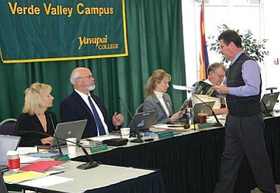 VVN/Philip Wright<br/>Casey Rooney, representing the Cottonwood Economic Development Council, handed out some information to members of the Yavapai College Governing Board during its community forum Tuesday on the importance of the wine industry in the Verde Valley.