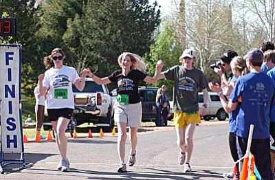 The Mickelsens cross the finish line Saturday at Riverfront Park. <br /><br /><!-- 1upcrlf2 -->VVN/Sean Morris<br><b><u><a href="Formlayout.asp?formcall=userform&form=22">Click here to purchase photos of this event</a></b></u>