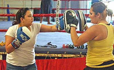 <b>Jasmin Mongi</b> works with <b>Genoa Altamirano</b> during a Monday afternoon workout at Golden Cobra Gym. VVN/Sean Morris