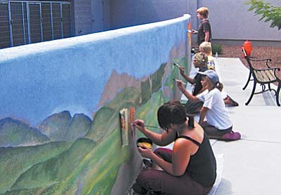 Young volunteers working on the courtyard mural at the Verde Valley Humane Society.