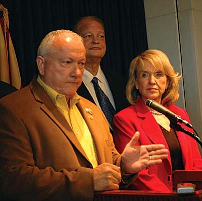 Senate President Russell Pearce explains Monday why he thinks the hardships Arizona faces from illegal immigration should allow the state to start enforcing an immigration law approved last year but placed on hold by a federal judge. With him are Attorney General Tom Horne and Gov. Jan Brewer. (Capitol Media Services photo by Howard Fischer)