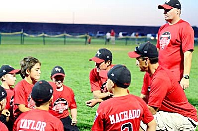 Coaches of the 9 and 10-year-old Verde Valley All Stars talk to their players after winning the District 10 title Friday in Chino Valley. VVN/Sean Morris