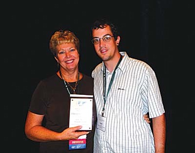 Rhonda Gonzalez and her son, Jordan Engler, posed with the Distinguished Teacher Award she received during the 2011 National Conference on Geographic Education in Portland. Gonzalez teaches American history at Cottonwood Middle School. Courtesy Photos