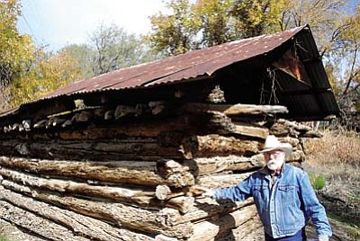 Bill Cowan shows off the historic smokehouse on the property. William Beriman Back had a pig farm that was once located beneath a travertine ledge on the side of Montezuma Well. Sometime, most likely in the 1890s, he built the smokehouse to smoke hams. It is believed to be one of the oldest buildings in the Verde Valley.<br /><br /><!-- 1upcrlf2 -->