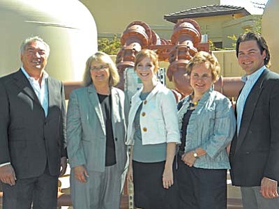 Big Park Water operators and  officials from the Water Infrastructure Finance Authority stand in front of the hardware system that removes arsenic from drinking water in the Big Park System, that serves 80% of the Village water customers.  The company won the Arizona-wide award for best WIFA drinking water project for 2011. Standing (l-r) are President Steve Gudovic, WIFA Executive Director Sandy Sutton, Melonie Ford of WIFA, Mary Lynn Gudovic and Operations Manager Nick Gudovic. Bill Garfield of Arizona Water, who sits on the WIFA board, says the project shows “how much a relatively small company can accomplish with a complex project.”  By designing and building the arsenic treatment facility, the Big Park Water company saved about half the cost of contracting-out the project. The company has seven wells, each now in compliance with EPA arsenic standards. Villager/ Jon Hutchinson