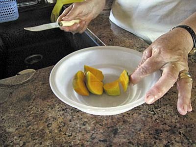 Deb Rhodes shows the persimmons she grows in Sedona.