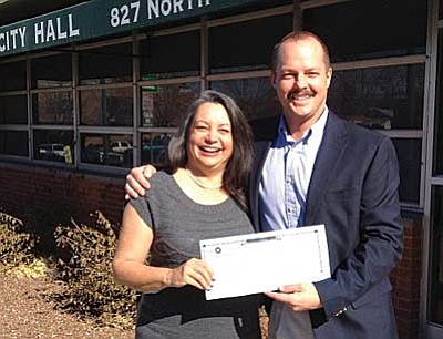Adopt For Life President Kyla Allen receives a $900 check Sedona Verde Valley Association of Realtors President Gary Lund