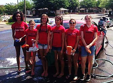 Some of the members of Aftershock pose for a picture during a car wash fundraiser. The club was washing cars on June 22 to help raise money to go to a distance-running summer camp in Flagstaff, hosted by Bo Reed, and to help fund trips to El Paso for the Junior Olympics cross country regionals and nationals. VVN/Travis Guy