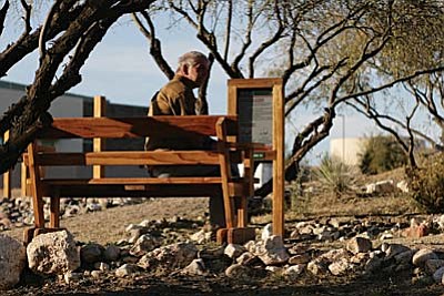 Larry Dakin, a rancher at Rainbow Acres, sits on one of the new benches at the new exercise trail on Thursday, Nov. 14. Dakin says the trail is “good for the ranchers, if they need to exercise.” VVN/Bill Helm