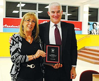Retiring Mingus Union High School District board secretary and executive assistant Val Moore accepted a plaque Tuesday night from superintendent Paul Tighe during the last meeting of her 34-year career. Yvonne Gonzalez/VVN