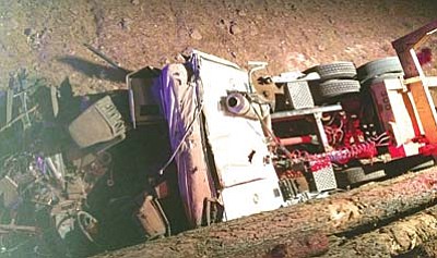 A big-rig driver suffered minor injuries when his tracter-trailer overturned on Interstate 17, dumping logs on the highway April 4.