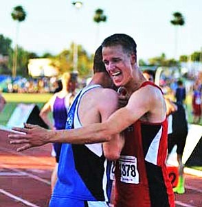 Ryan Talbot hugs a competitor after winning the 400 meter race. VVN/Travis Guy