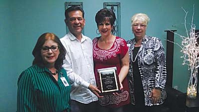 Hospice of the Pines Administrator Beth Funk and Community Relations Coordinator Julie Keeney presents the Hometown Hero Award to Cottonwood’s Frank and Kathleen Nevarez. 