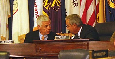 Rep. Jeff Miller, R-Fla., right, chariman of the House of Veteran Affairs Committee, talks with Rep. Mike Michaud, D-Maine, the ranking Democrat on the committee, before a May hearing on problems at Department of Veterans Affairs medical facilities. (Cronkite News Service photo by Julianne Logan)