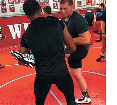 Wyatt Midkiff helps new wrestler Javin Helsel. VVN/Derek Evans