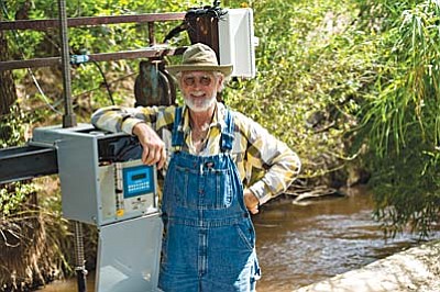 Frank Germinden, a Camp Verde landowner and volunteer “ditch guy,” shows off the new automated ditch flow system. Courtesy Mark Skalny/TNC