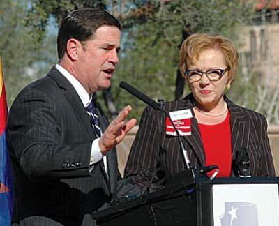 In his State of the State Address, Arizona Governor Doug Ducey, left, called for creating an Arizona Public School Achievement District that would turn over space that isn’t being used by traditional schools to charter schools and other qualifying schools.