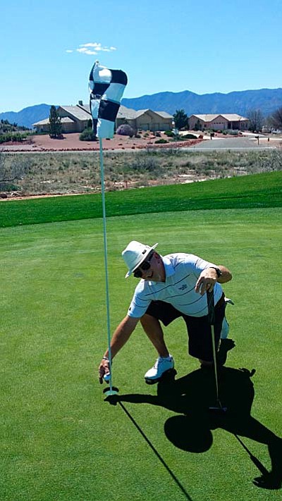 On Wednesday March 26, 2105, Scott Robinson made a Hole in One on the number four hole (a par three) at Verde Santa Fe Golf Course. Scott used a #4 Hybrid from 165 yards. Scott was playing with Mike Wright PGA and Manager of Verde Santa Fe and Tim Riordan. The picture shows Scott getting his ball out of the hole. Picture courtesy of Mike Wrigh