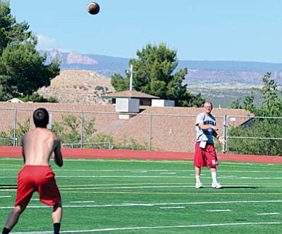 Head coach Bob Young throws to a player during Tuesday’s spring football practice. The Marauders are hoping for improvement after back to back 5-5 seasons.  VVN/Derek Evans