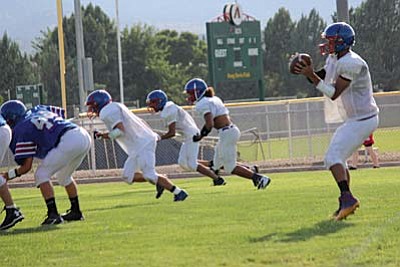 Trevor Heyer takes a snap in the shotgun, with three wide receivers panned out to the right. VVN photo by Greg Macafee.