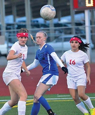 Two Mingus soccer players try to gain control of the ball during a game last year against the Prescott Badgers on December 11, 2014. (Photo by Vyto Starinskas)