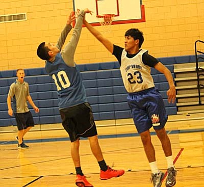 Javier Perez tries puts up a shot against fellow senior Thomas Herrera during practice on Monday. Perez returns as the Cowboys leading scorer this season as the Cowboys look to improve on their 2014 season in which they finished sub .500. (Photo by Greg Macafee)