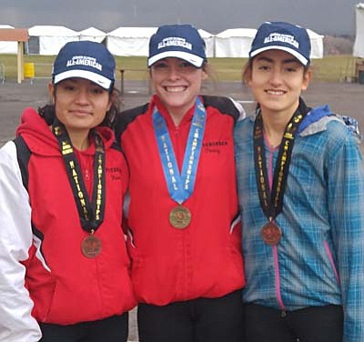 Pictured from left: Karen Arellano, Penny Fenn and Allyson Arellano, pose with their All-American hats and medals at Balloon Fiesta Park in Albuquerque, New Mexico. All three earned All-American honors but it was Penny Fenn who came home with as a National Champion this weekend, clocking the 5-kilometer course in 19-minutes and 52-seconds to earn a 7-second victory in the 17-18 girls division. (Photo Courtesy of Micah Swenson)