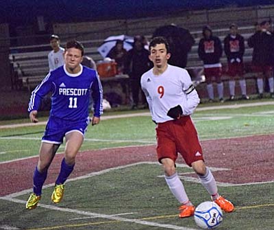 Luis Hernandez passes the ball Tuesday night against the Prescott Badgers. Hernandez netted two goals in the second-half against the Badgers as the Marauders earned their first home victory of the season. (Photo by Greg Macafee)